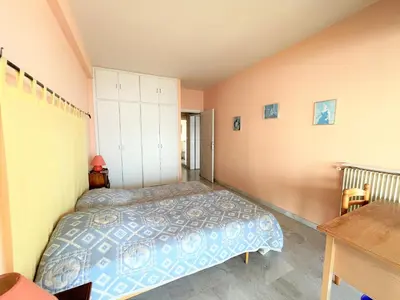 a bedroom with a bed and a desk in it at Appartement vue mer Carmino Ajaccio in Ajaccio
