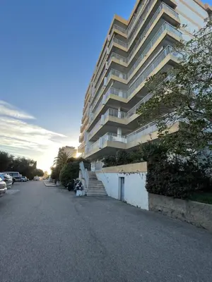 a large apartment building on the side of a street at Appartement vue mer Carmino Ajaccio in Ajaccio