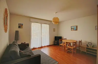 a living room with a couch and a table at Appartement Capo Rosso sanguinaires Ajaccio in Ajaccio