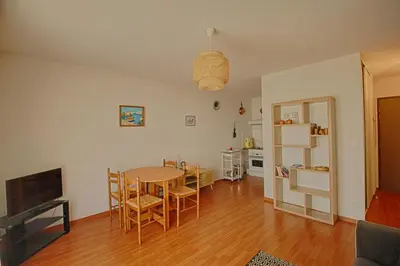 a kitchen and dining room with a table and chairs at Appartement Capo Rosso sanguinaires Ajaccio in Ajaccio