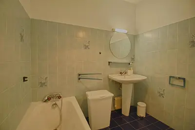 a bathroom with a tub and a sink and a bath tub at Appartement Les Crêtes Sanguinaires Ajaccio in Ajaccio