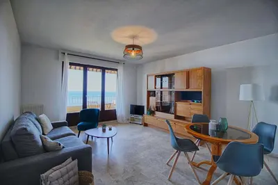 a living room with a couch and a table at Appartement Les Crêtes Sanguinaires Ajaccio in Ajaccio