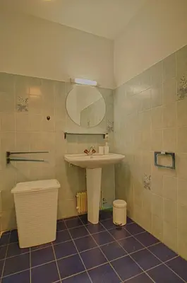 a bathroom with a sink and a mirror at Appartement Les Crêtes Sanguinaires Ajaccio in Ajaccio