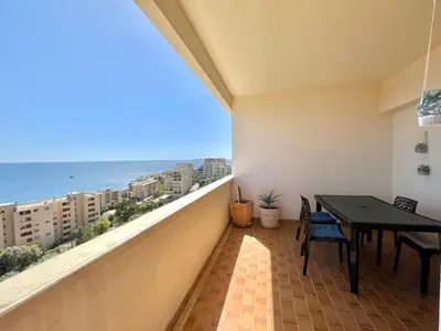 a balcony with a table and a view of the ocean at Appartement le Sicile sanguinaires Ajaccio in Ajaccio