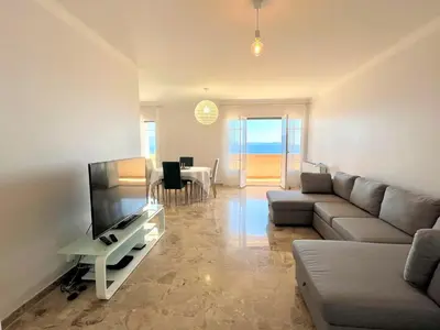 a living room with a couch and a television at Appartement le Sicile sanguinaires Ajaccio in Ajaccio