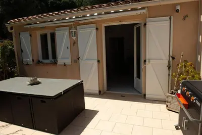 a building with an open garage with a stove at Villa SYMPHONY A PIANA CORSE DU SUD in Piana