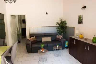 a living room with a couch and a table at Villa SYMPHONY A PIANA CORSE DU SUD in Piana