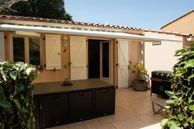 an outdoor kitchen with a counter in a backyard at Villa SYMPHONY A PIANA CORSE DU SUD in Piana