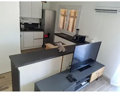 a teddy bear sitting on a counter in a kitchen at Appartement proche plage in Ajaccio