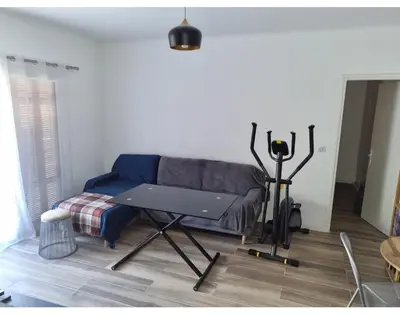 a living room with a couch and a table at Appartement proche plage in Ajaccio