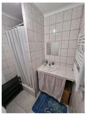 a bathroom with a sink and a mirror at Appartement proche plage in Ajaccio