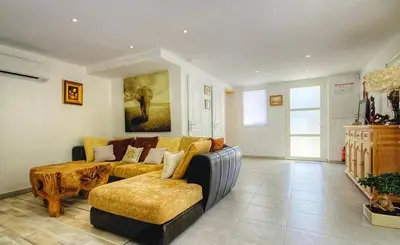 a living room with a couch and a coffee table at Villa terranga in Calenzana