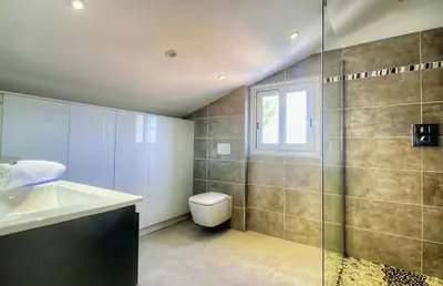 a bathroom with a shower and a toilet and a sink at Villa terranga in Calenzana