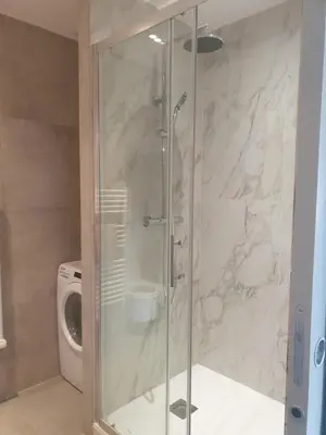 a shower with a glass door in a bathroom at Joli T3 sur le port de Bonifacio avec vue mer in Bonifacio