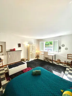 a large living room with a bed and a window at Appartement Haut de Villa centre-ville CORTE in Corte