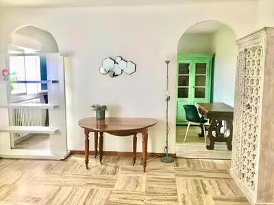 a living room with a table and a piano at Appartement Haut de Villa centre-ville CORTE in Corte