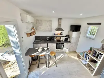 a small kitchen with a table and chairs in it at Studio Le Prunelli PORTICCIO in Porticcio