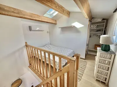 a small room with a crib in a house at Studio Le Prunelli PORTICCIO in Porticcio