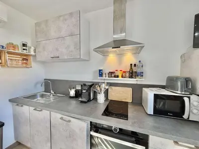 a kitchen with a sink and a microwave at Studio Le Prunelli PORTICCIO in Porticcio