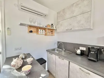 a kitchen with a sink and a counter top at Studio Le Prunelli PORTICCIO in Porticcio
