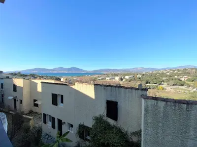 an old building with a view of the ocean at Appartement 86 Terra Bella 1 Porticcio in Porticcio