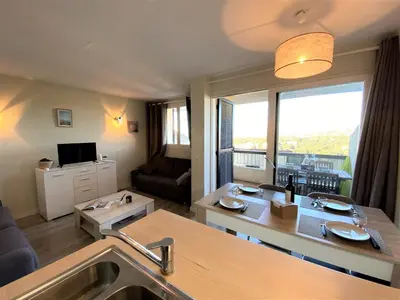 a kitchen and living room with a large window at Appartement 86 Terra Bella 1 Porticcio in Porticcio