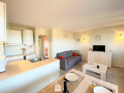 a kitchen and living room with a couch and a table at Appartement 86 Terra Bella 1 Porticcio in Porticcio