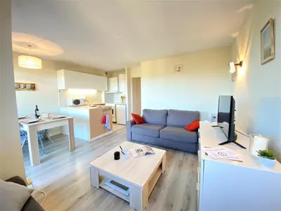 a living room with a blue couch and a table at Appartement 86 Terra Bella 1 Porticcio in Porticcio