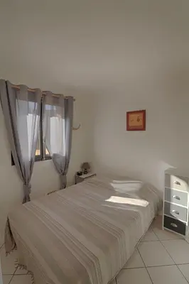 a bedroom with a bed and a window at Appartement 102 Terra Bella 1 Porticcio in Porticcio