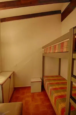 a bedroom with two bunk beds and a desk at Appartement 318 Paesolu 1 PORTICCIO in Porticcio