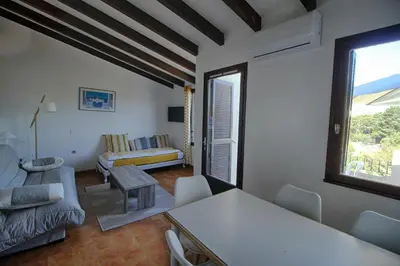 a living room with a couch and a table at Appartement 318 Paesolu 1 PORTICCIO in Porticcio