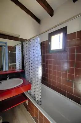a bathroom with a tub and a sink and a window at Appartement 318 Paesolu 1 PORTICCIO in Porticcio