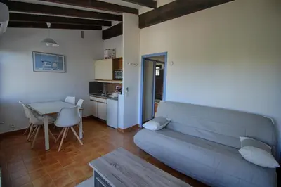 a living room with a couch and a table at Appartement 318 Paesolu 1 PORTICCIO in Porticcio