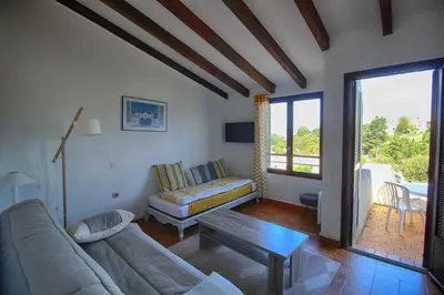 a living room with a couch and a table at Appartement 318 Paesolu 1 PORTICCIO in Porticcio