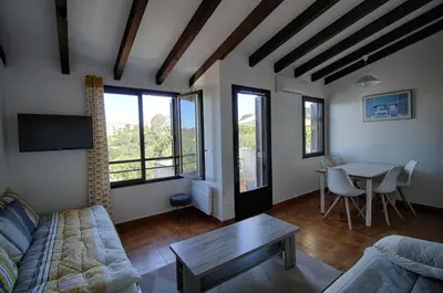 a living room with a couch and a table at Appartement 318 Paesolu 1 PORTICCIO in Porticcio