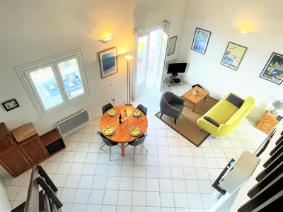 an overhead view of a living room with a table and chairs at Appartement A Stagnola PORTICCIO in Porticcio