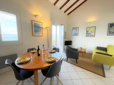 a living room with a wooden table and chairs at Appartement A Stagnola PORTICCIO in Porticcio