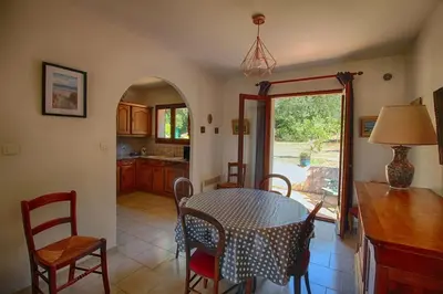 a kitchen and dining room with a table and chairs at VILLA 200 m de la plage La Liscia TIUCCIA in Casaglione