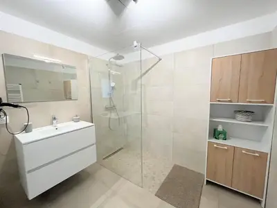 a bathroom with a glass shower and a sink at Appartement 2 pièces Les Jardins de Livia 1 PORTICCIO in Porticcio