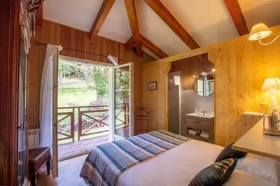 a bedroom with a bed and a window and a sink at BAVELLA VISTA in Zonza