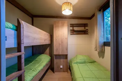 two bunk beds in a small room with a lamp at BAVELLA VISTA in Zonza