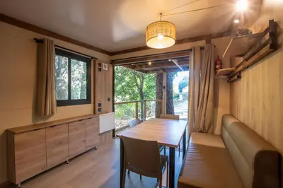a dining room with a table and a window at BAVELLA VISTA in Zonza