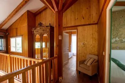 a room with wooden walls and a staircase in a house at BAVELLA VISTA in Zonza