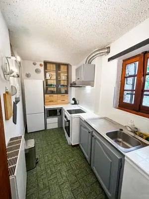a kitchen with a sink and a counter top at 5 Min de la Plage - T4 avec Piscine & Tennis in Propriano