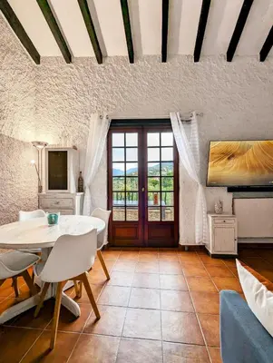 a living room with a table and chairs at 5 Min de la Plage - T4 avec Piscine & Tennis in Propriano