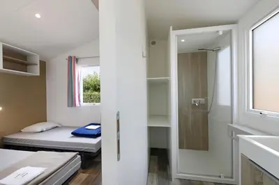a small room with a bed and a window at Camping Rondinara in Bonifacio