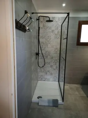 a shower with a glass door in a bathroom at Location Casa Di Lesia à Sotta / Porto-Vecchio in Sotta