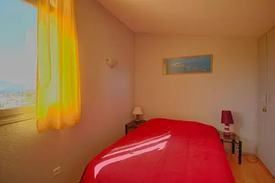 a bedroom with a red bed and a window at Villa Terra Bella 2 PORTICCIO in Porticcio