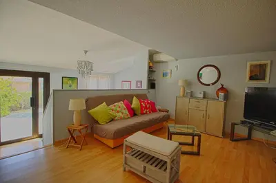 a living room with a couch and a television at Villa Terra Bella 2 PORTICCIO in Porticcio
