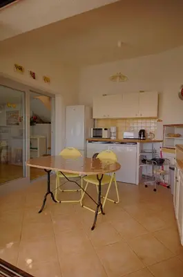 a kitchen with a table and two chairs in it at Villa Terra Bella 2 PORTICCIO in Porticcio